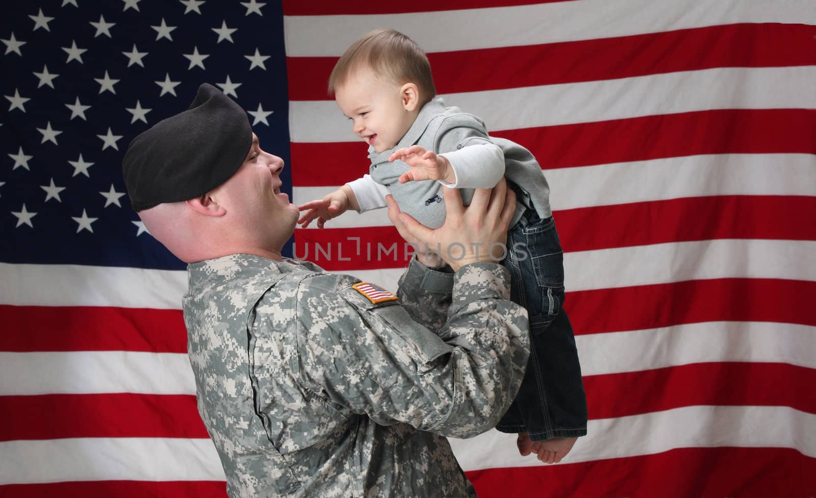 American Soldier holds his infant son by libyphoto