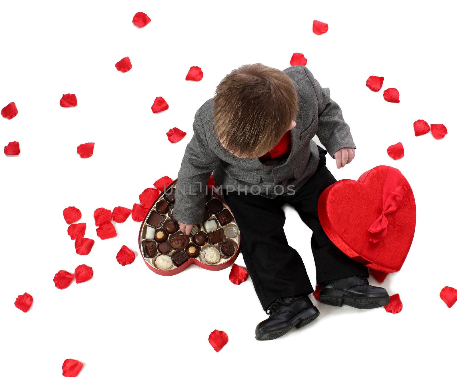 A young boy enjoys a box of valentine candy