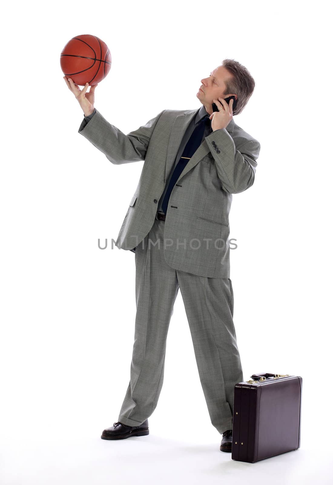 Business Man Holding a Basket Ball and Cell Phone by libyphoto