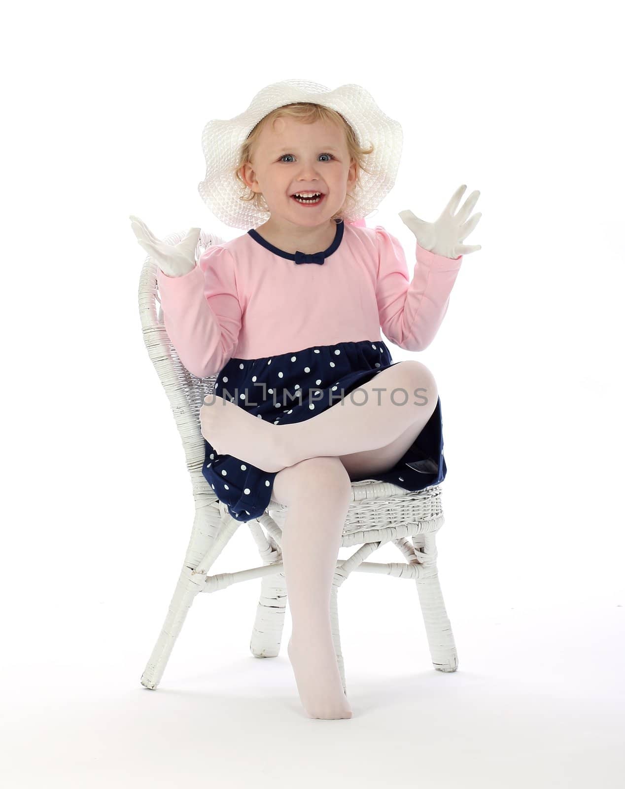 A small girl is happy about a secret surprise on a white background