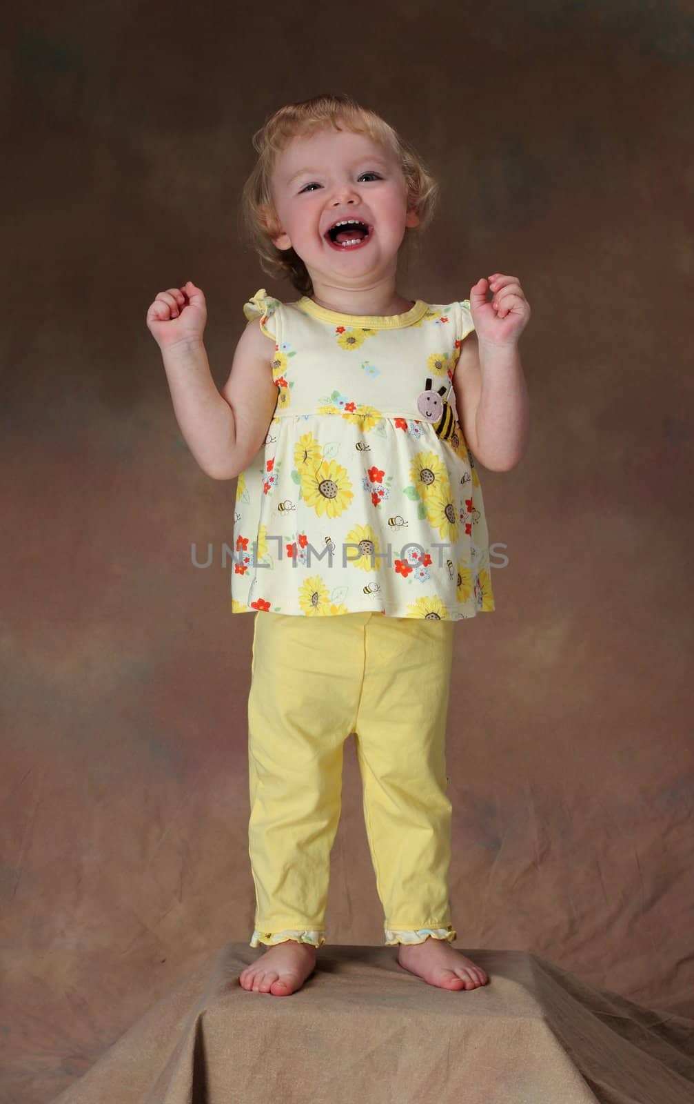 A young girl laughs at a funny joke