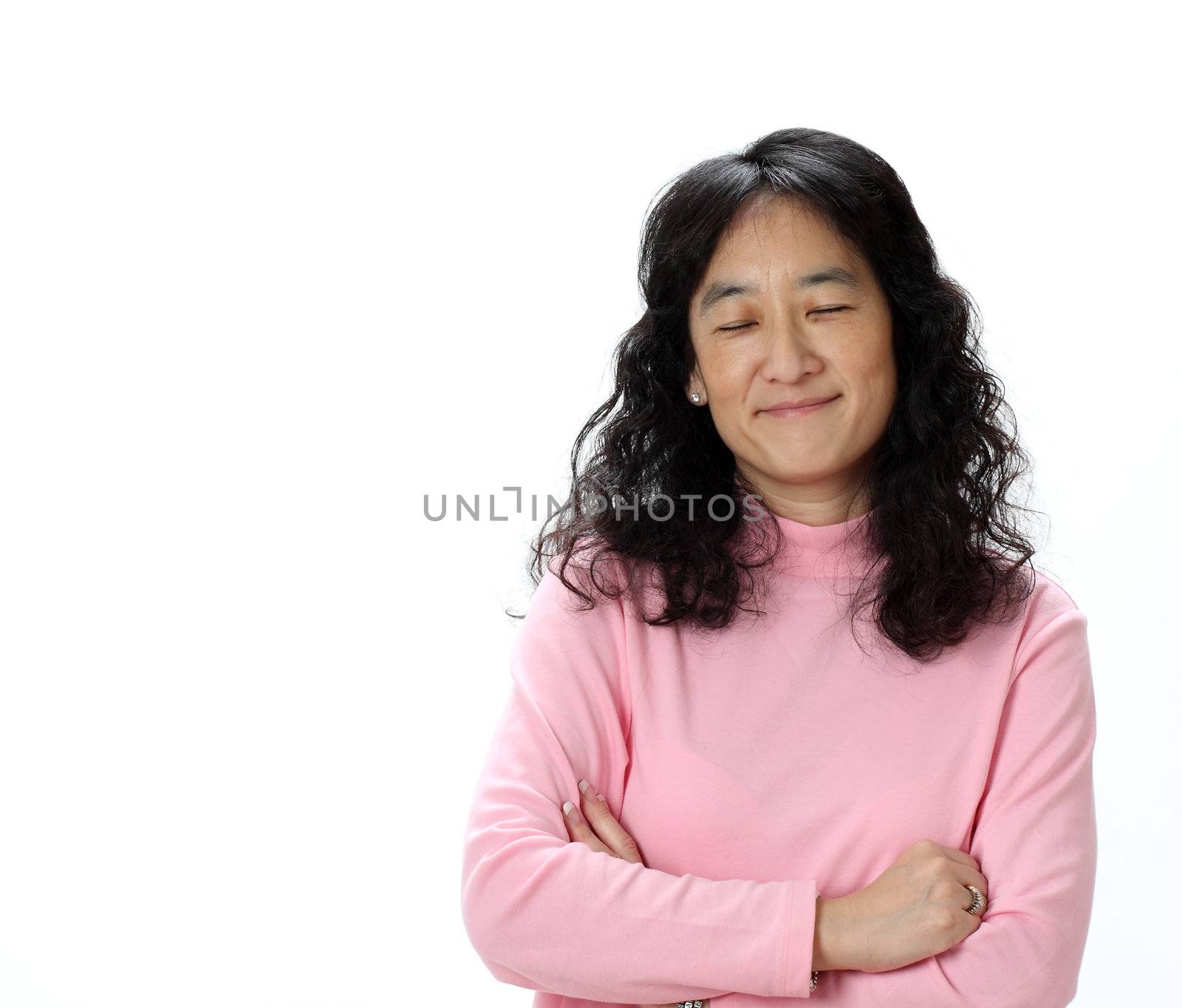 A Beautiful Asian woman Smiles While Thinking Happy Thoughts With Her Eyes Closed