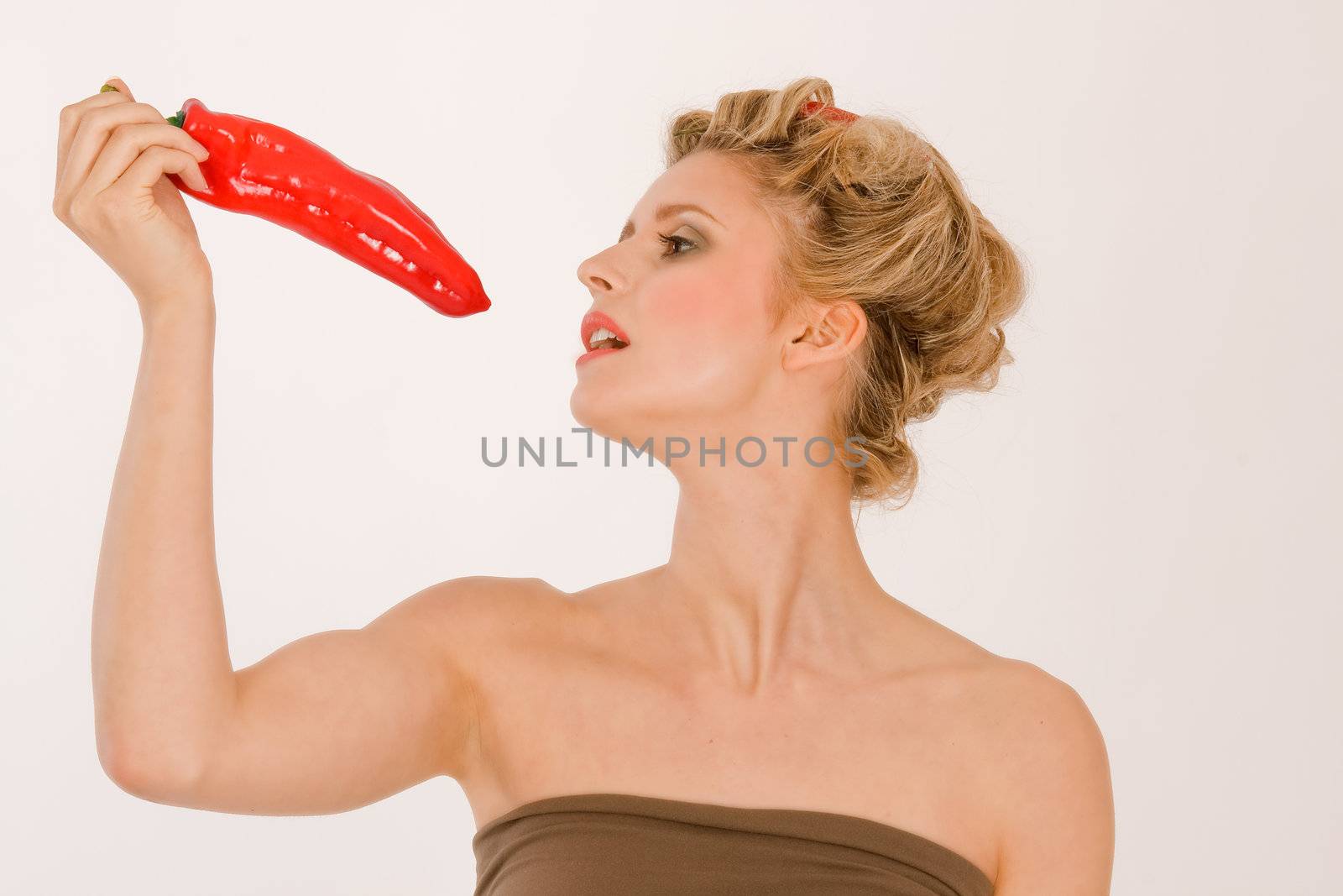 Blonde young woman with hair in chili peppers and Parika