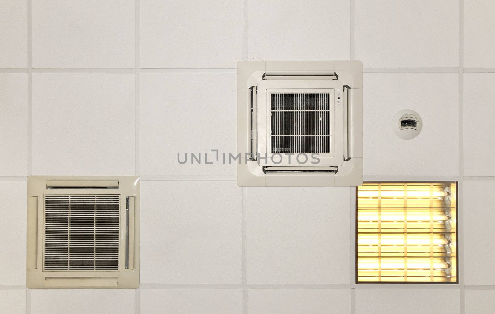Air conditioner systems in place with light on a white roof