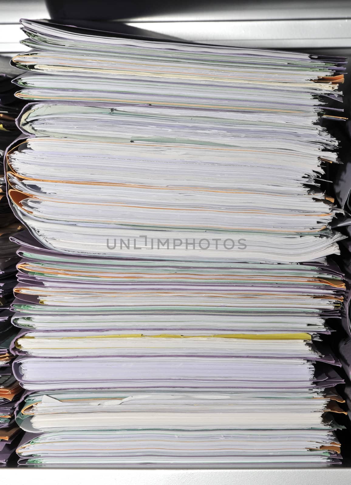 Stack of folders in a cupboard