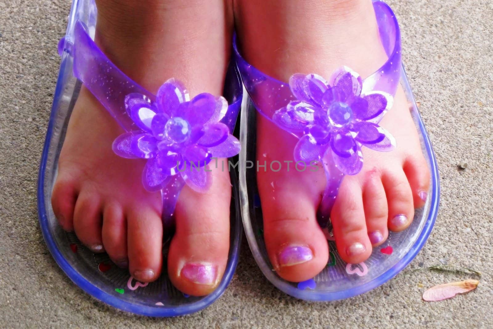 little girl's feet and toes wearing purple sandals