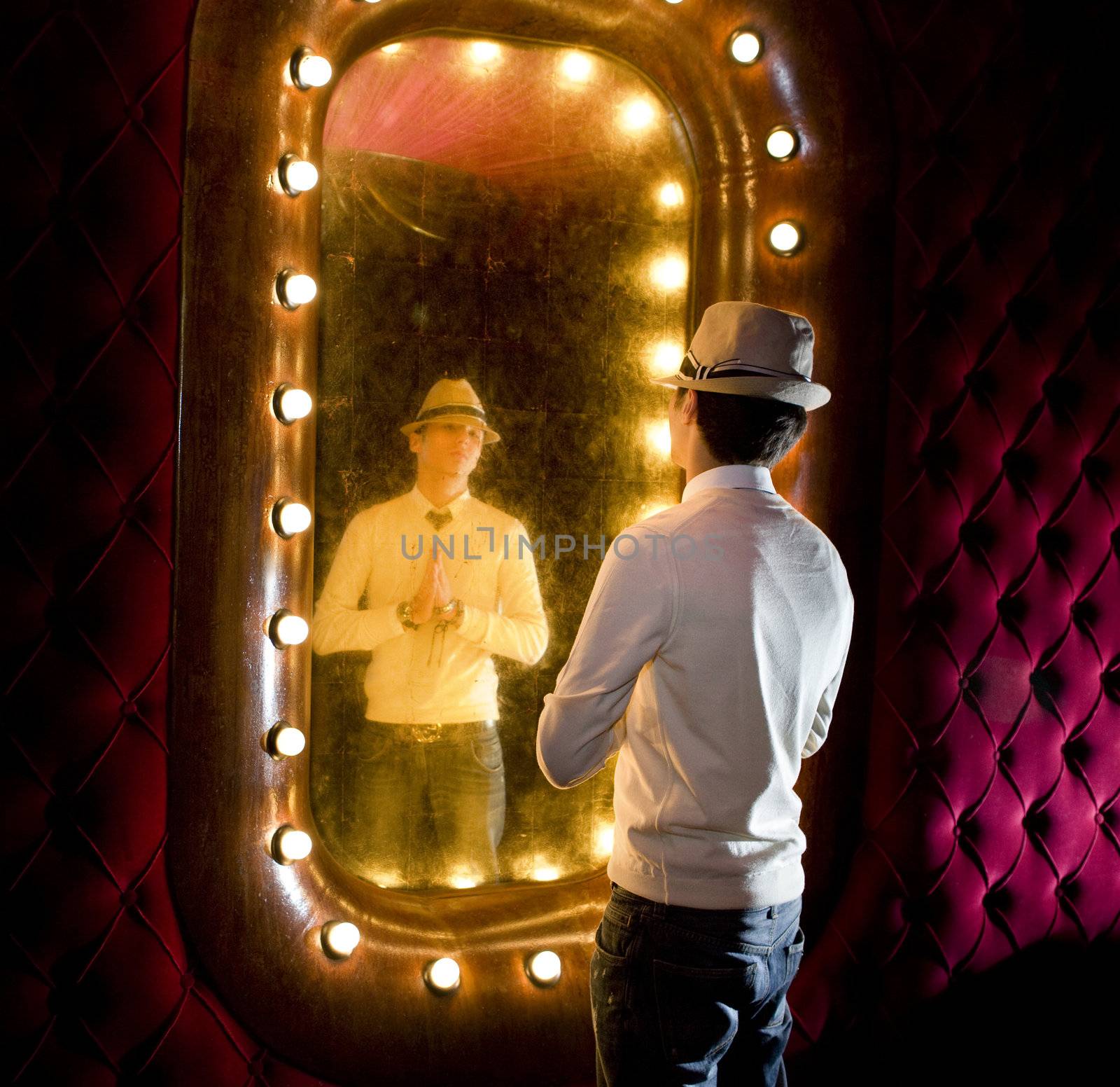 retro man looks on mirror by ssuaphoto