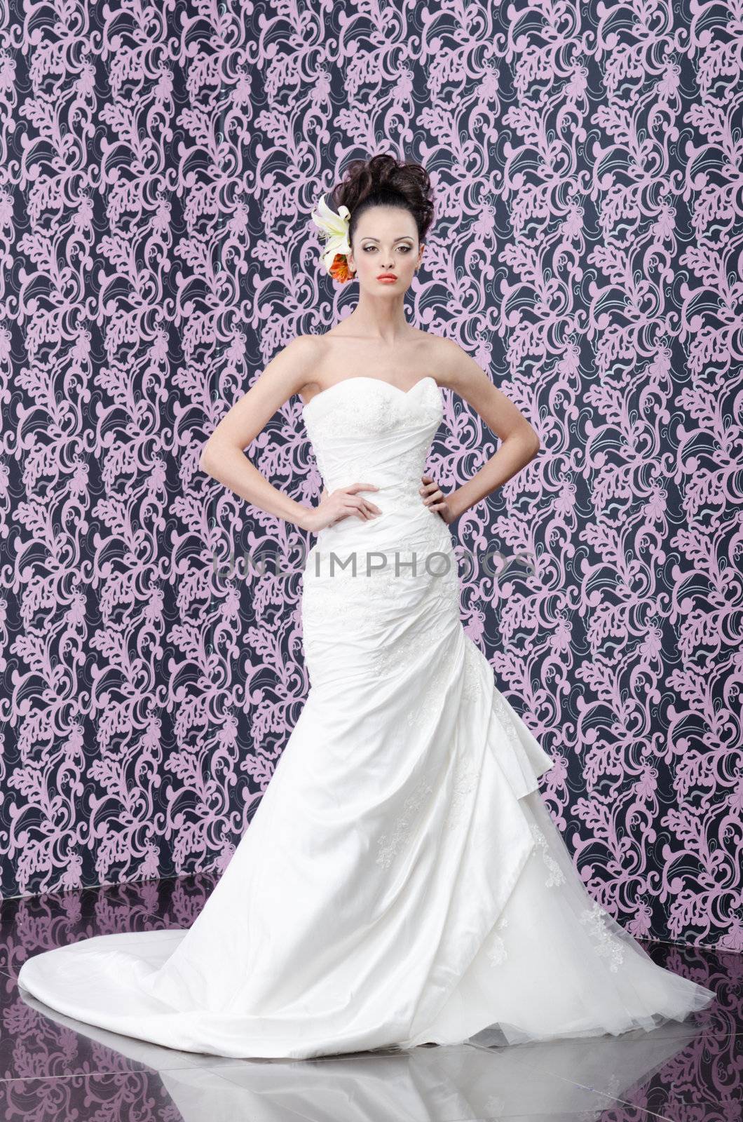 Full length portrait of the young adult bride with lily flowers in hair