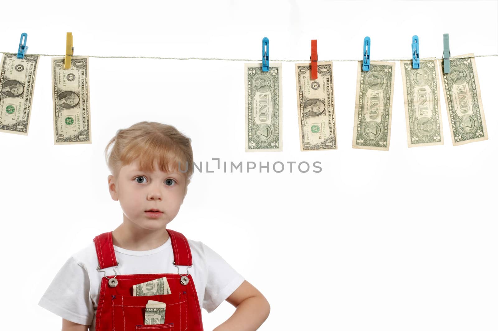 A girl standing under clothesline with dollars