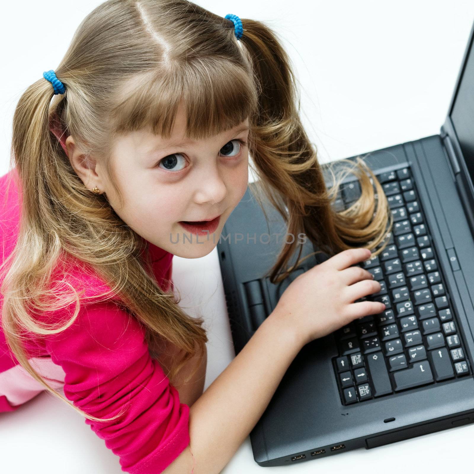 Stock photo: an image of a nice little girl with black laptop