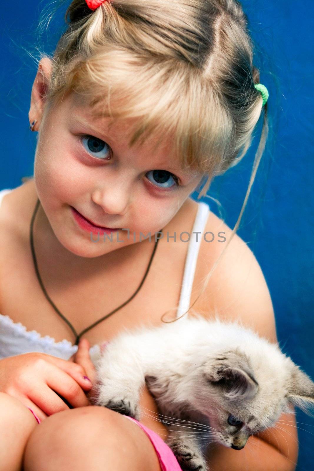 Smiling girl with a kitten in her arms