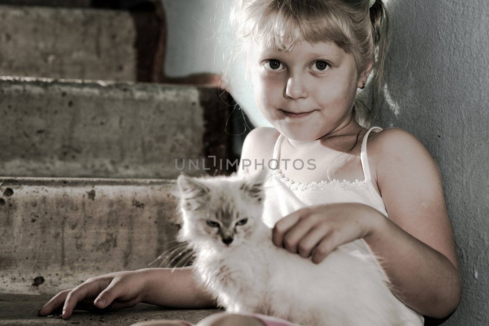 Friends. Smiling girl with a kitten in her arms
