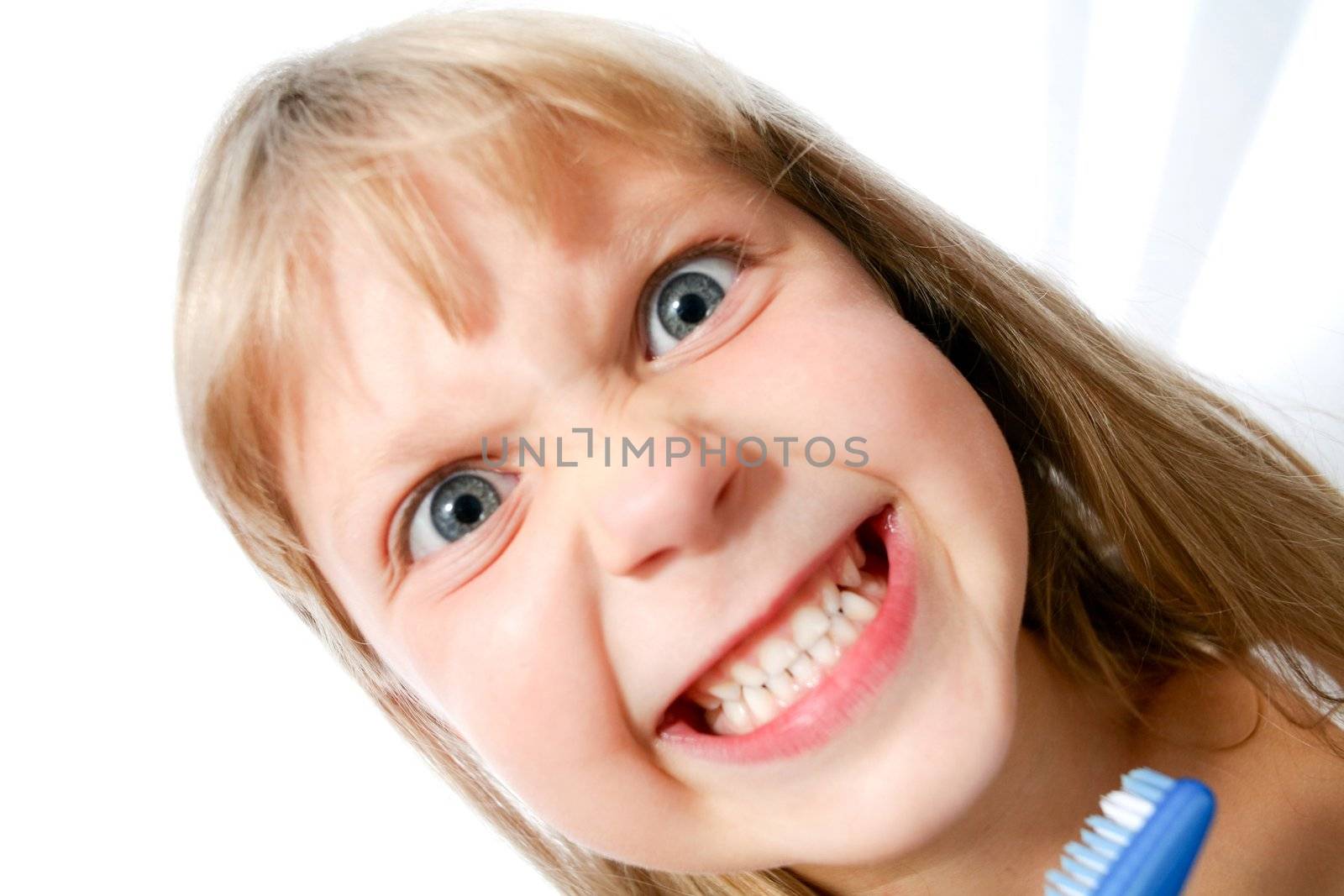 An image of little girl with toothbrush on neutral background