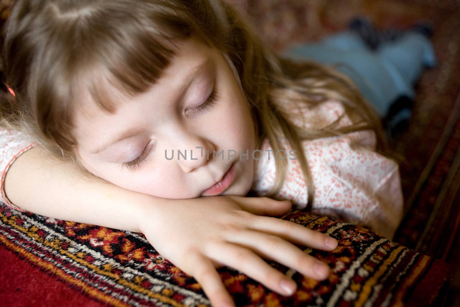 Stock photo: an image of a beautiful little girl sleeping on a sofa