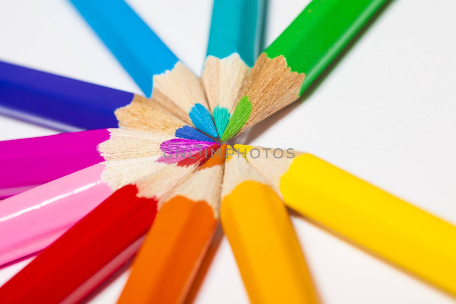 a group of colored pencils