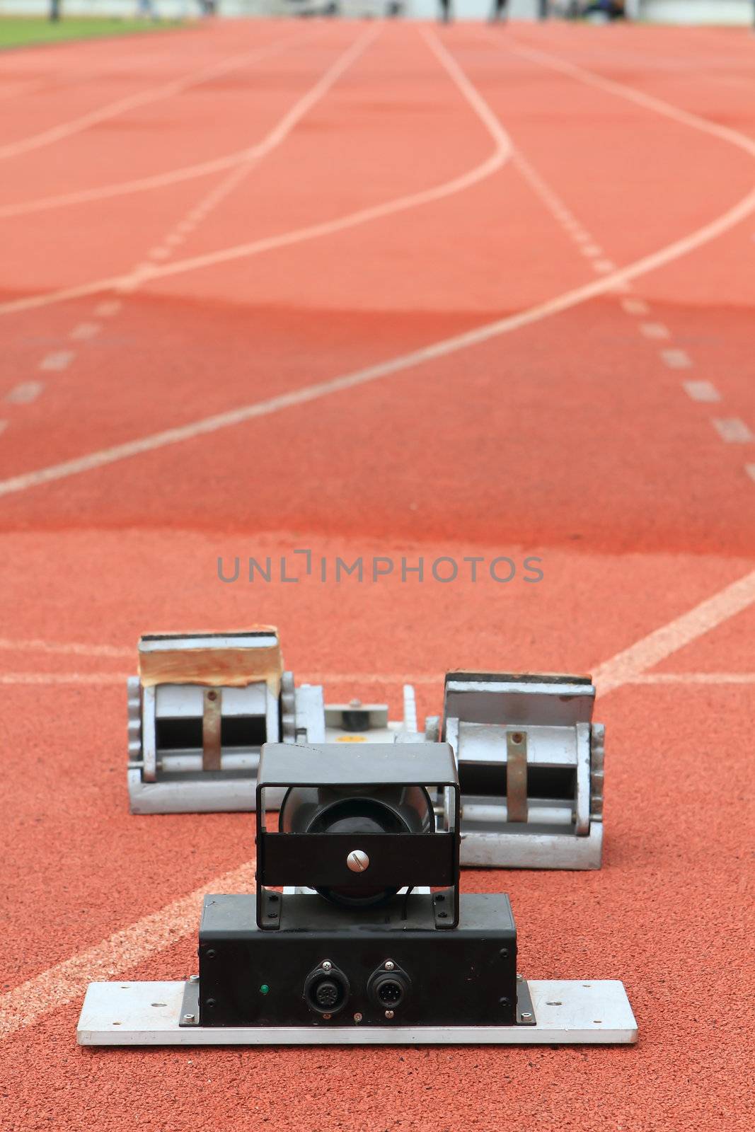 Athletics Starting Blocks on a red running track in a stadion 
 by rufous