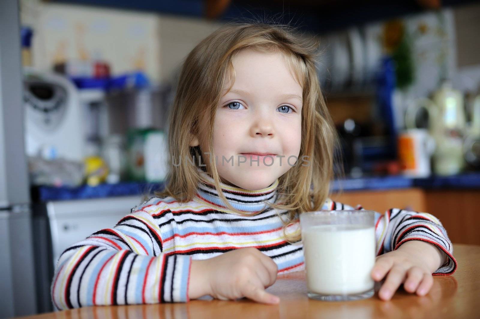 An image of a girl with a glass of milk
