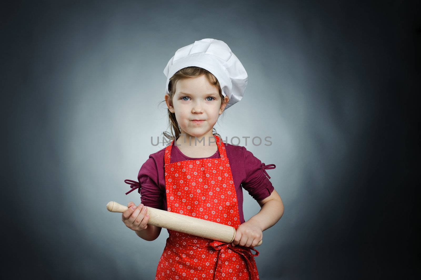 An image of a nice girl in a white hat with a rolling-pin