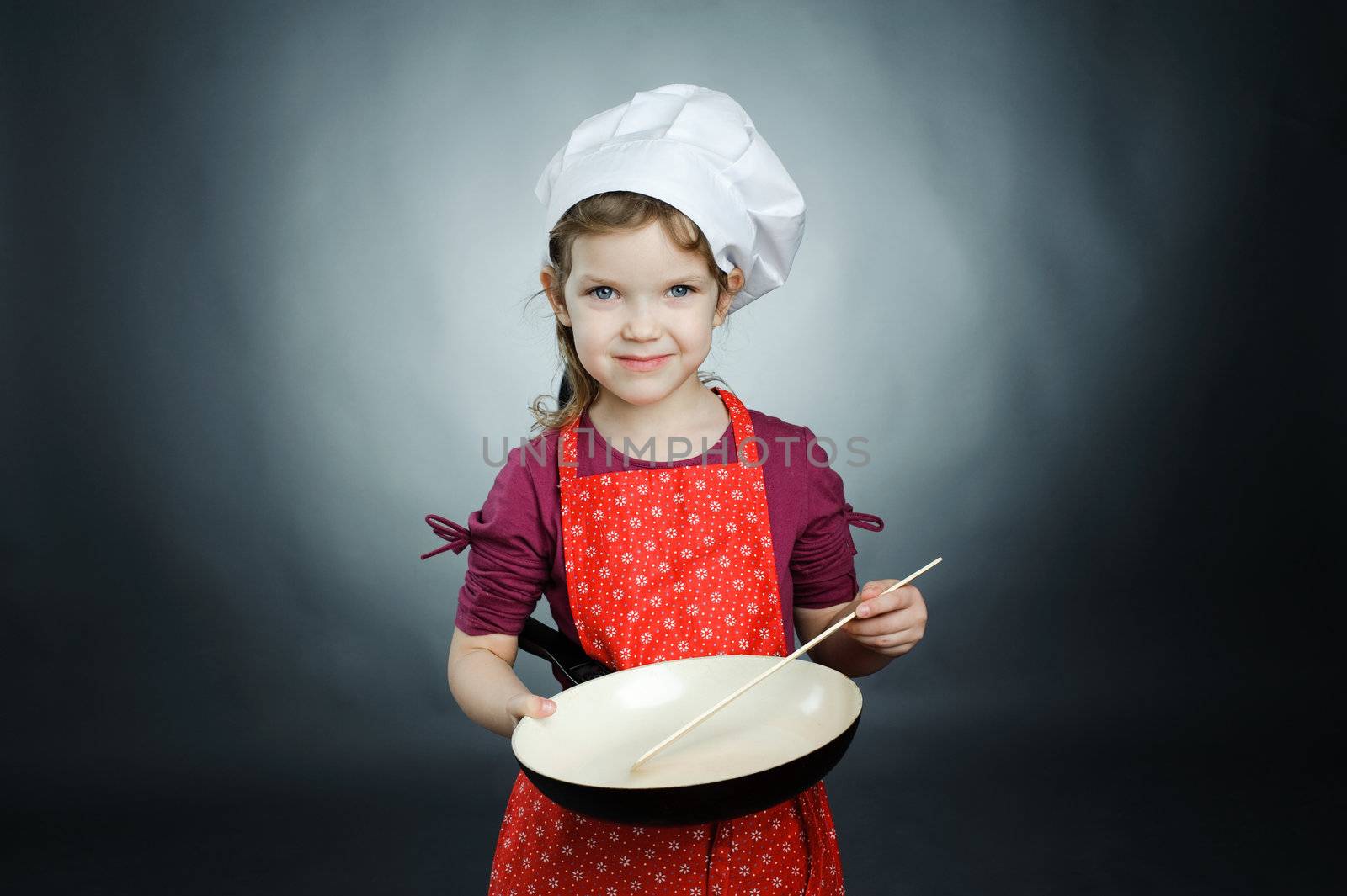 An image of a little girl in white hat with frying pan