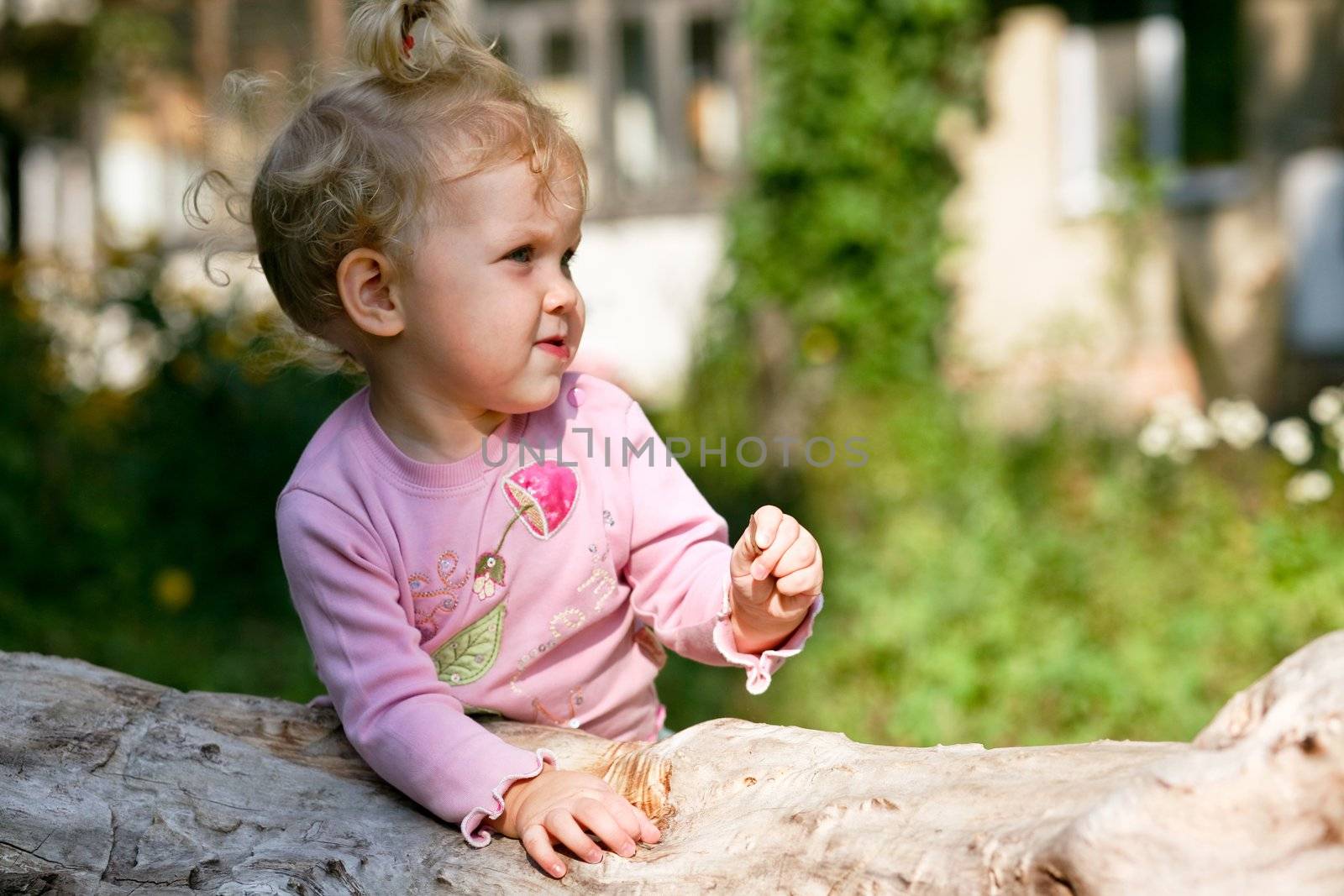 An image of little baby-girl playing outdoor