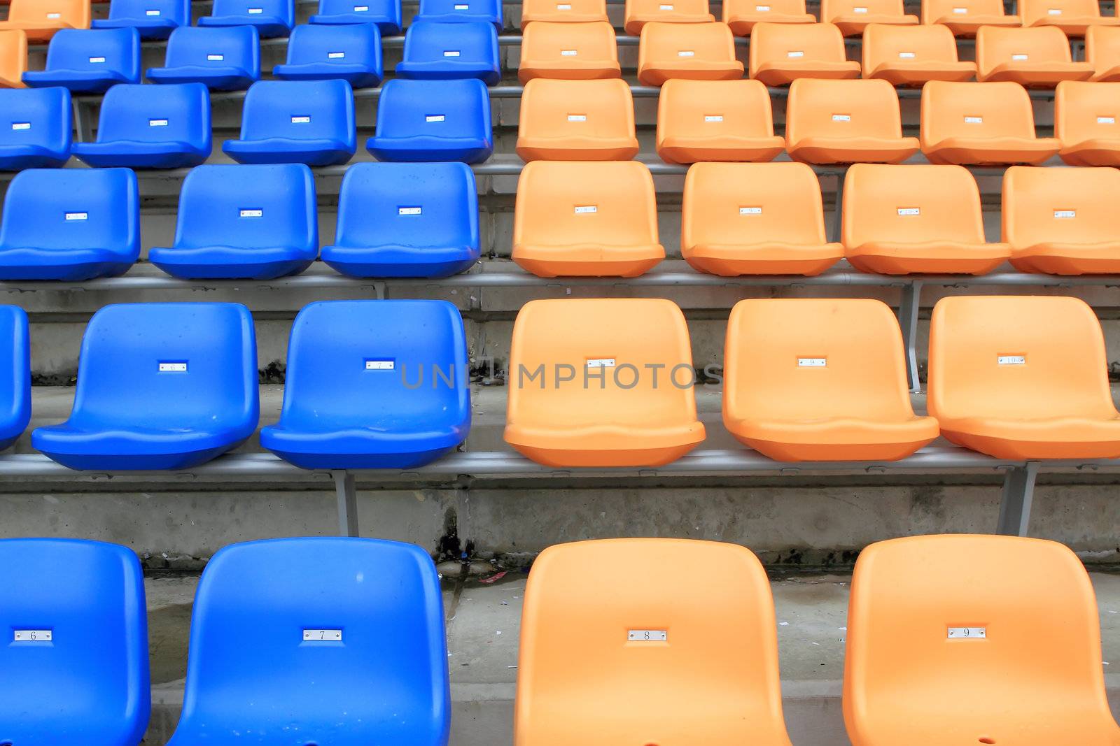 plastic, yellow and blue, new chairs in stadium.