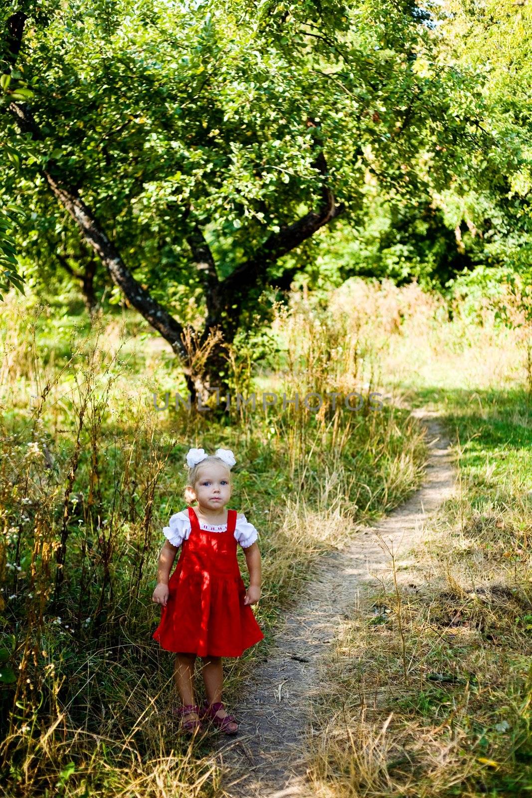 An image of a little girl standing on the lane