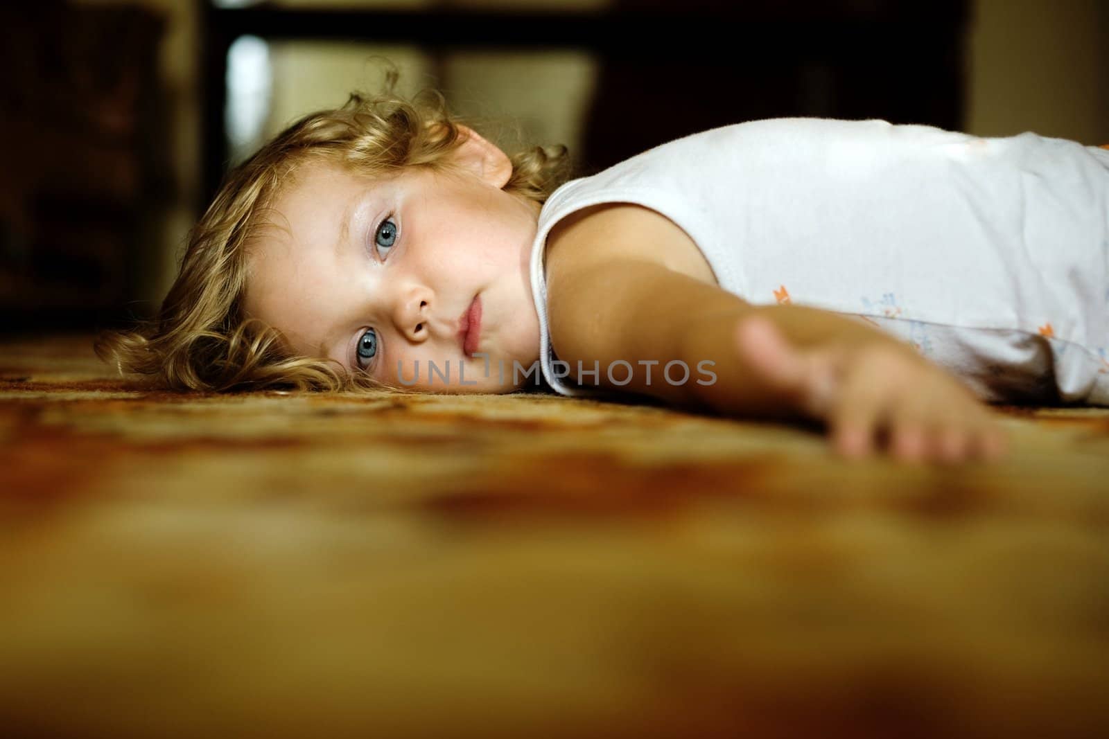 An image of  little girl lying on the floor
