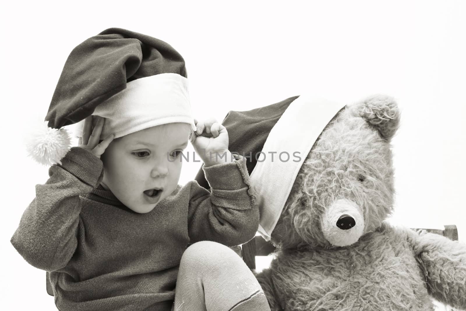 An image of nice baby in red hat with toy