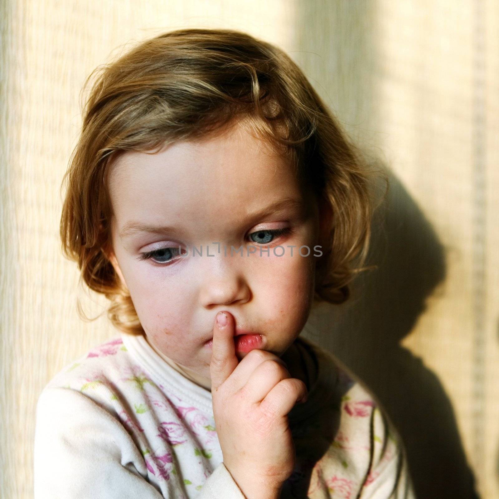 An image of a thoughtful beautiful little child