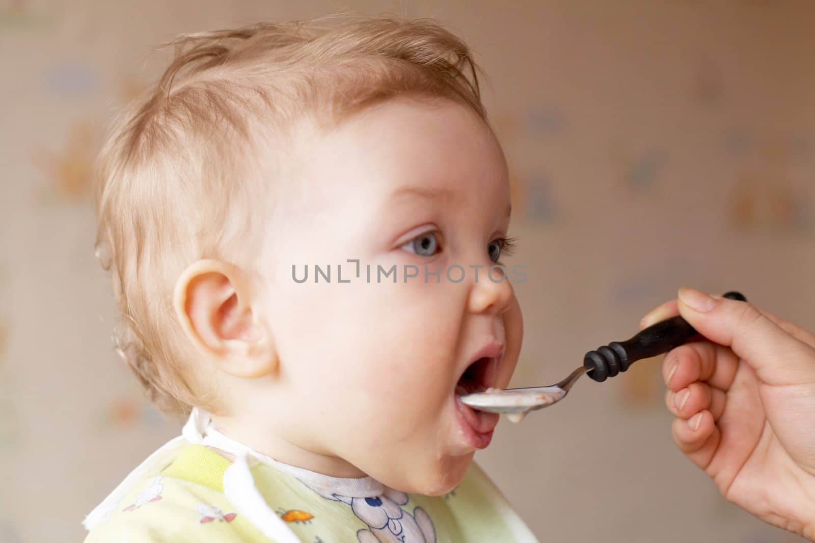 An image of a baby girl eating the porridge