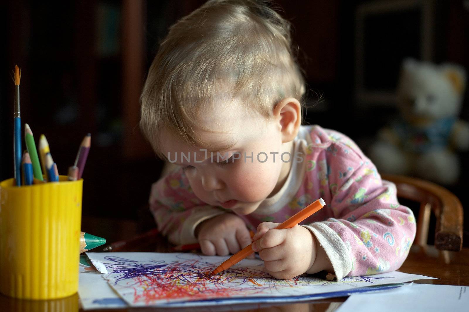 A girl with pencil drawing a picture