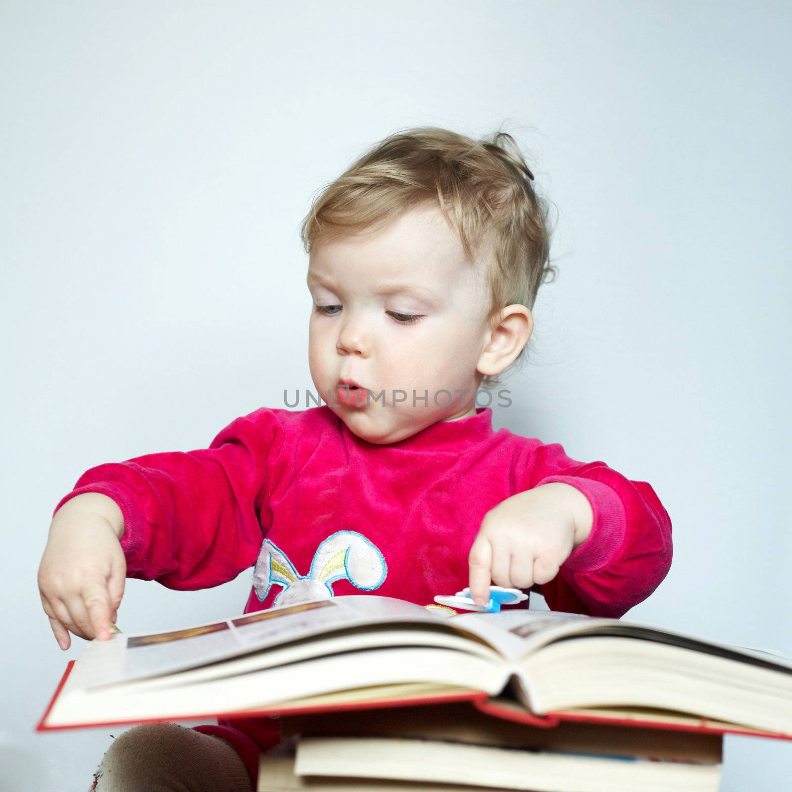 An image of child reading book