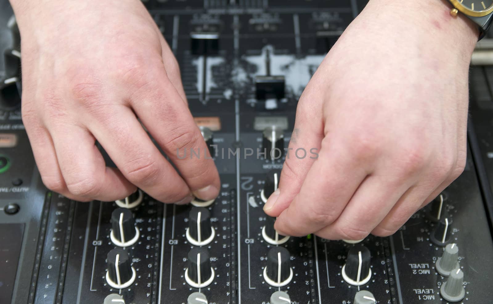 hands near the disc jockey music equipment
