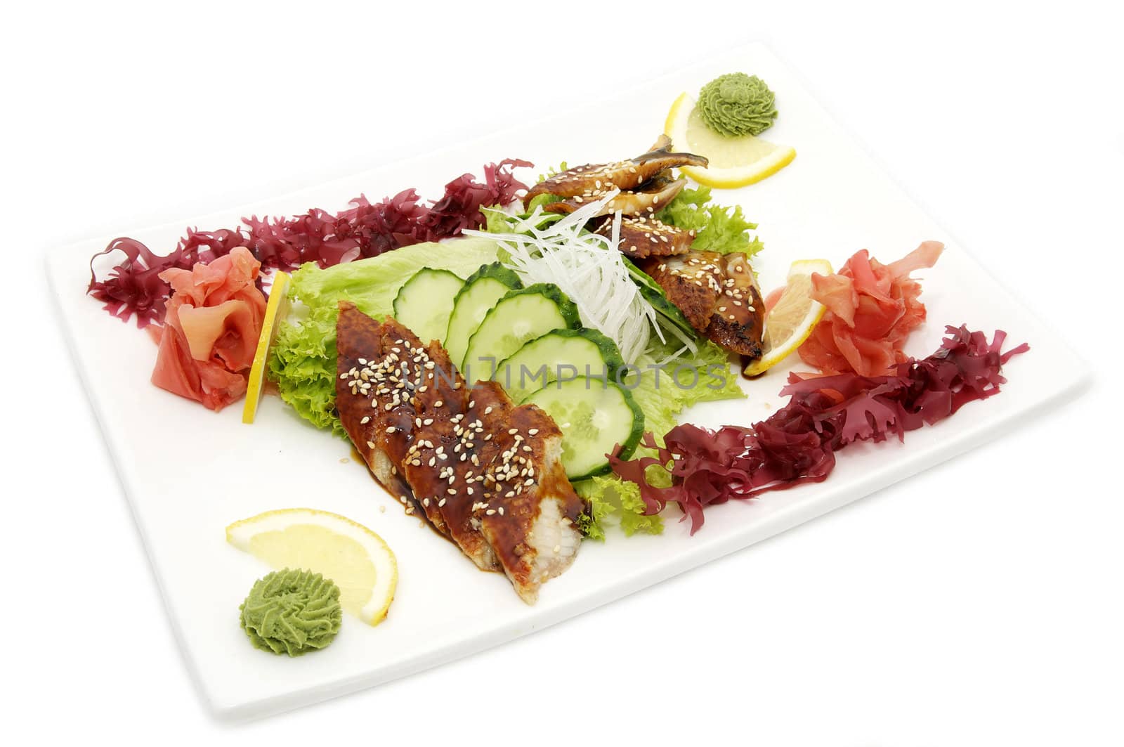 Fish and eel salad with vegetables on a white background