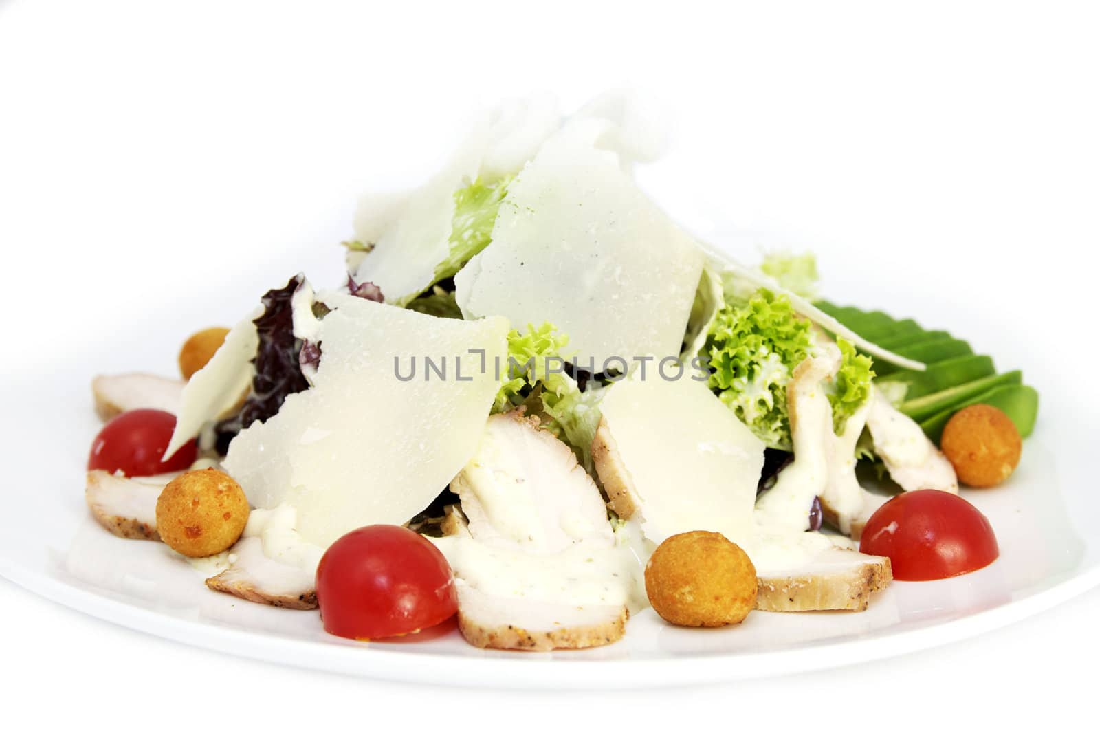 salad greens with meat and cheese on white background