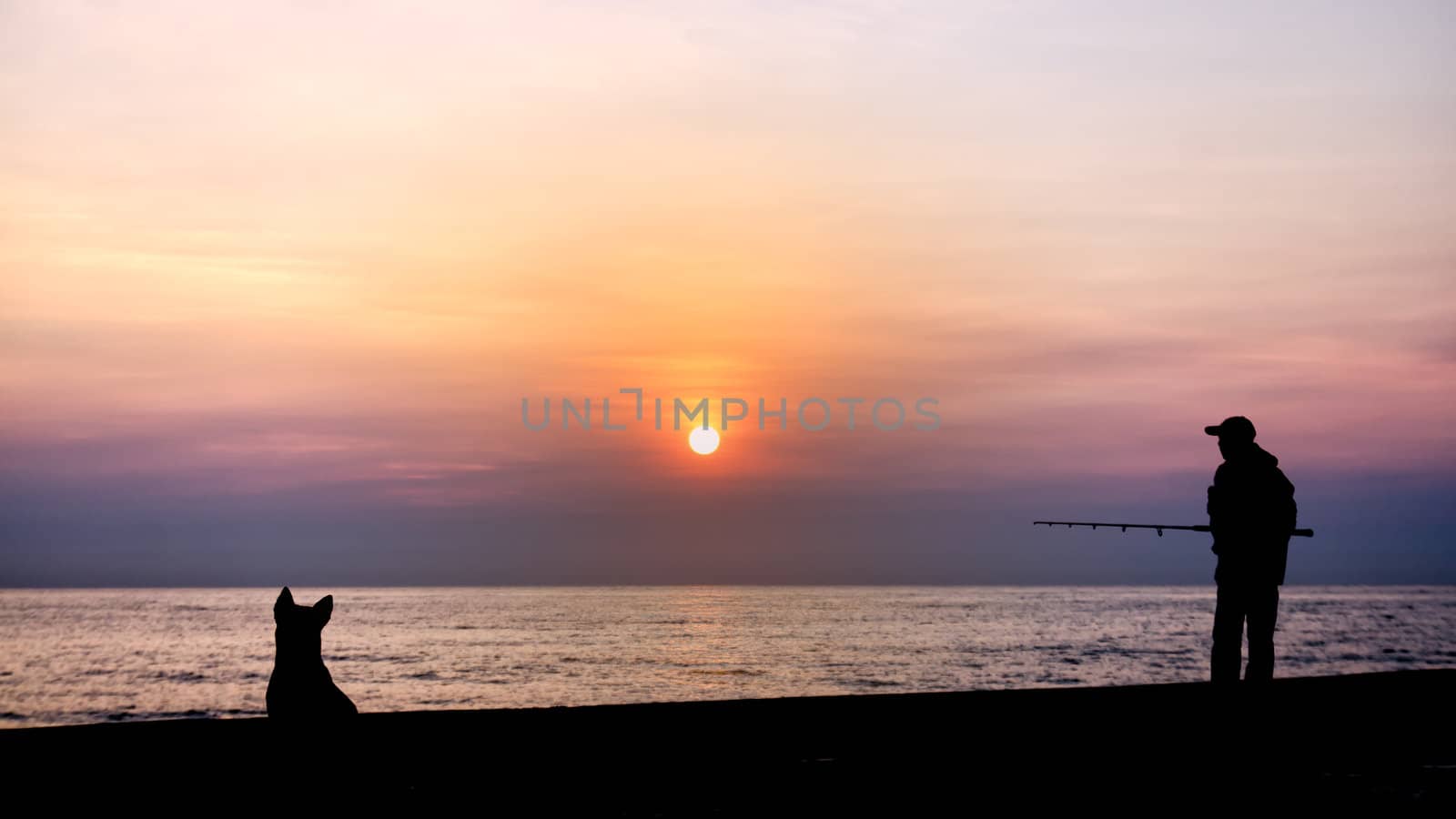 Silhouette of the fishing and dog by nuttakit