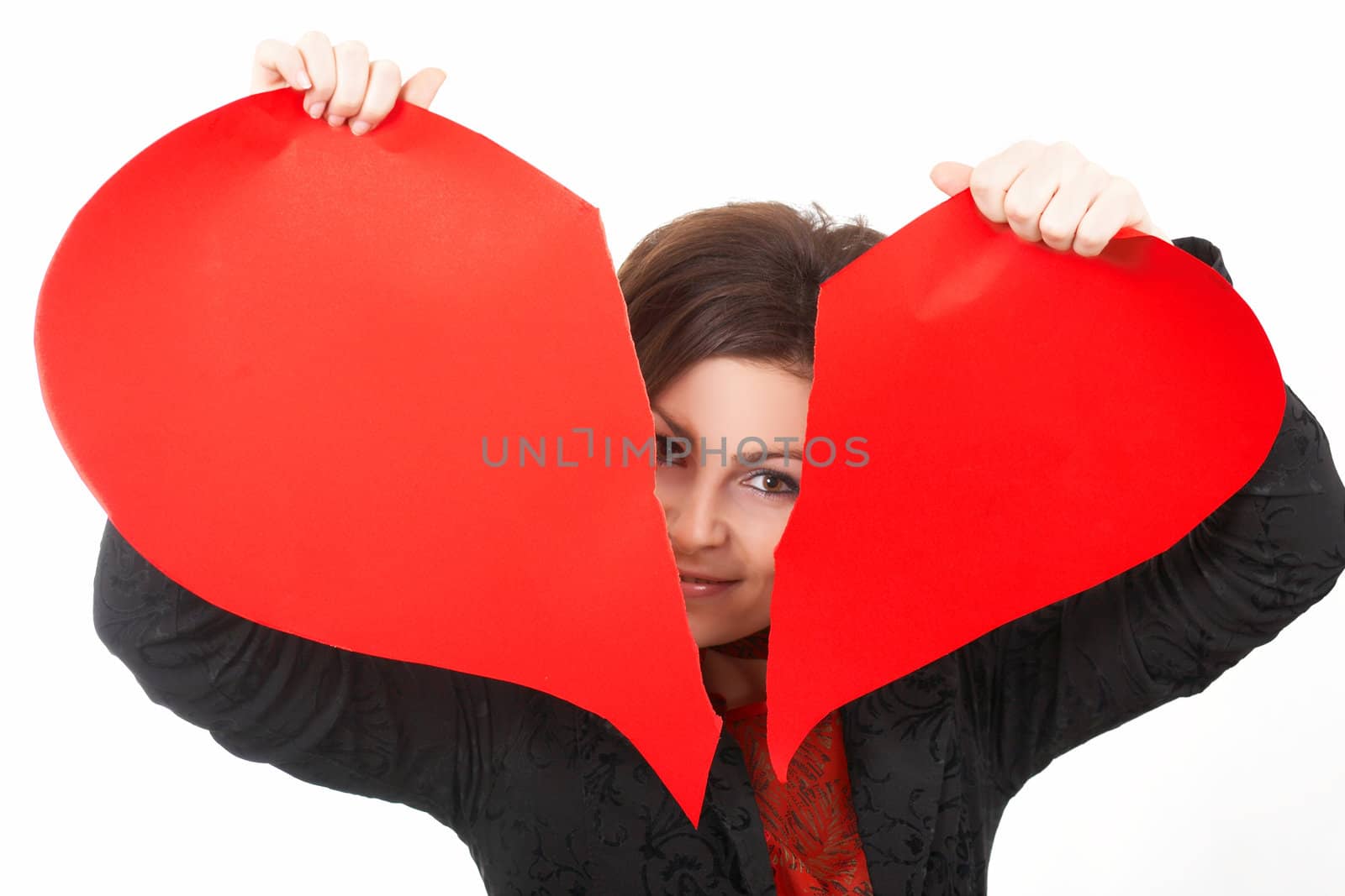 A smiling woman tearing a peper heart