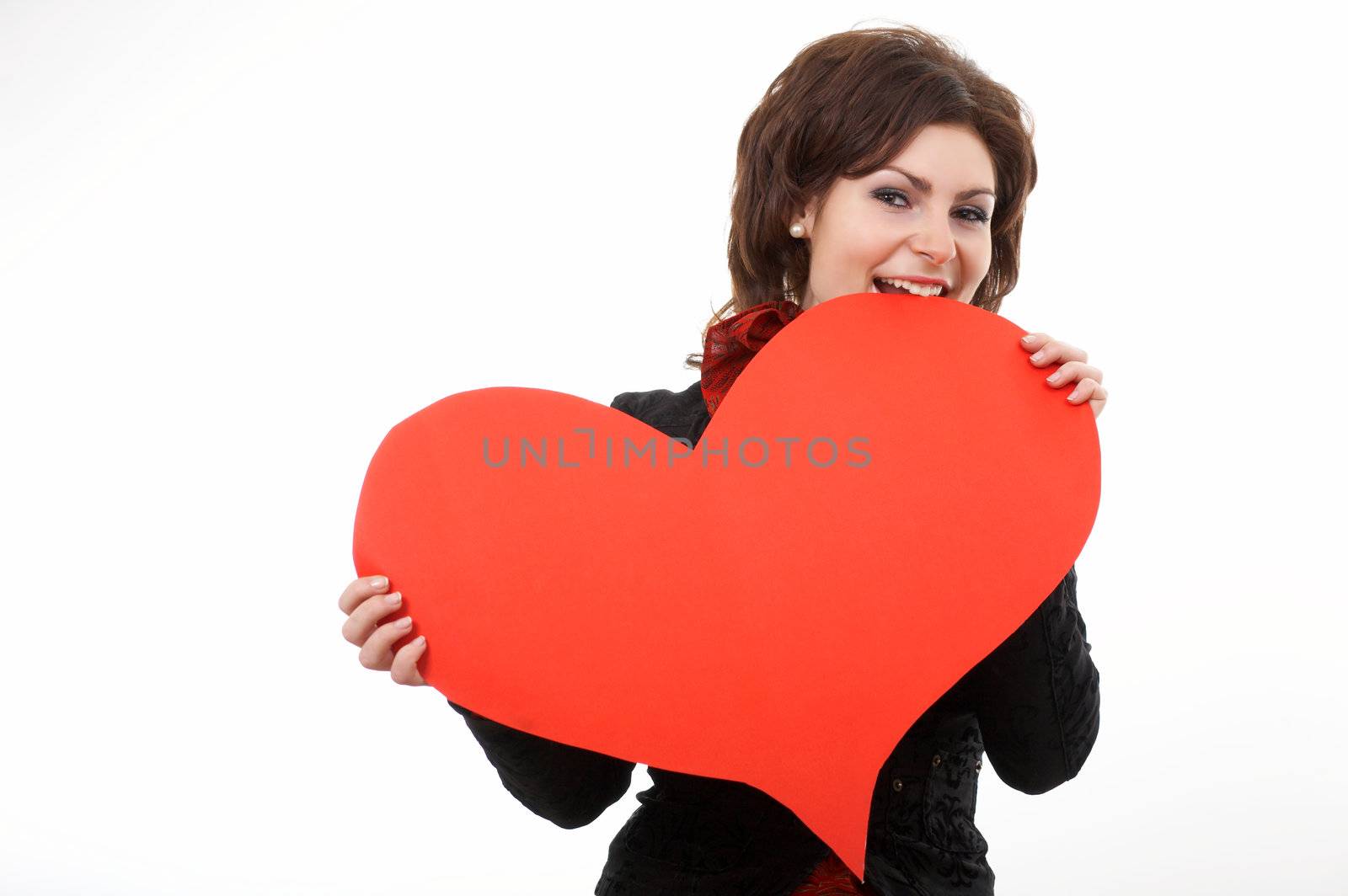 A woman biting a big red paper heart