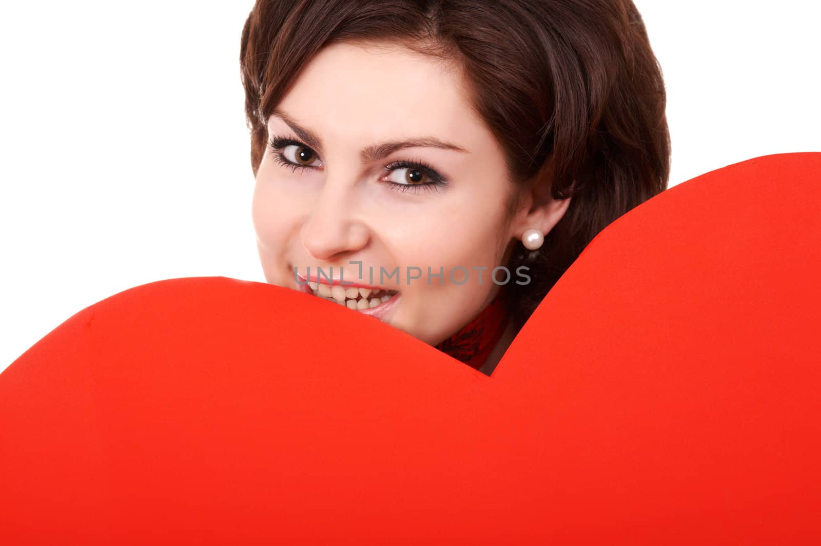 A girl keeps a big red paper heart