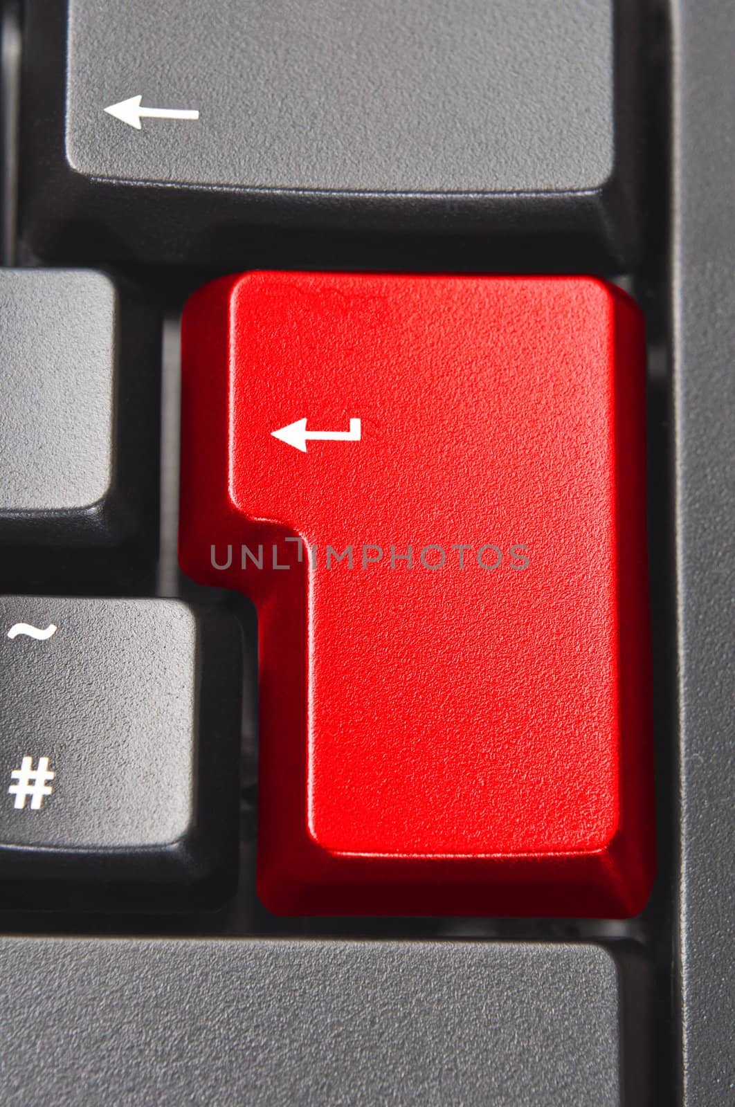 Close up (macro) shot of the 'Enter' aka 'Return' key on a black computer keyboard.  Coloured red with original word removed.