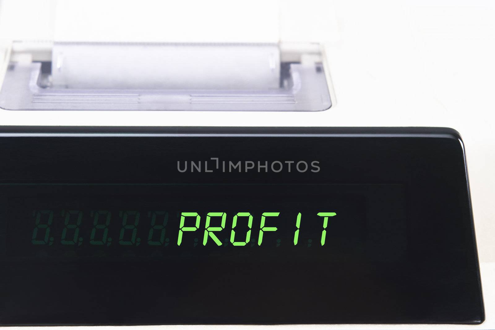 Close up of a calculator screen showing the word profit in bright green simulated LED.  Paper roll is visible in soft focus background.