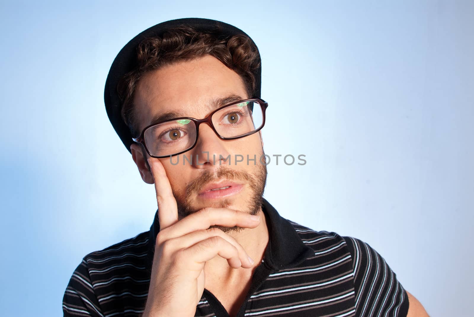 Young man modern nerd thinking wide angle portrait blue background by dgmata
