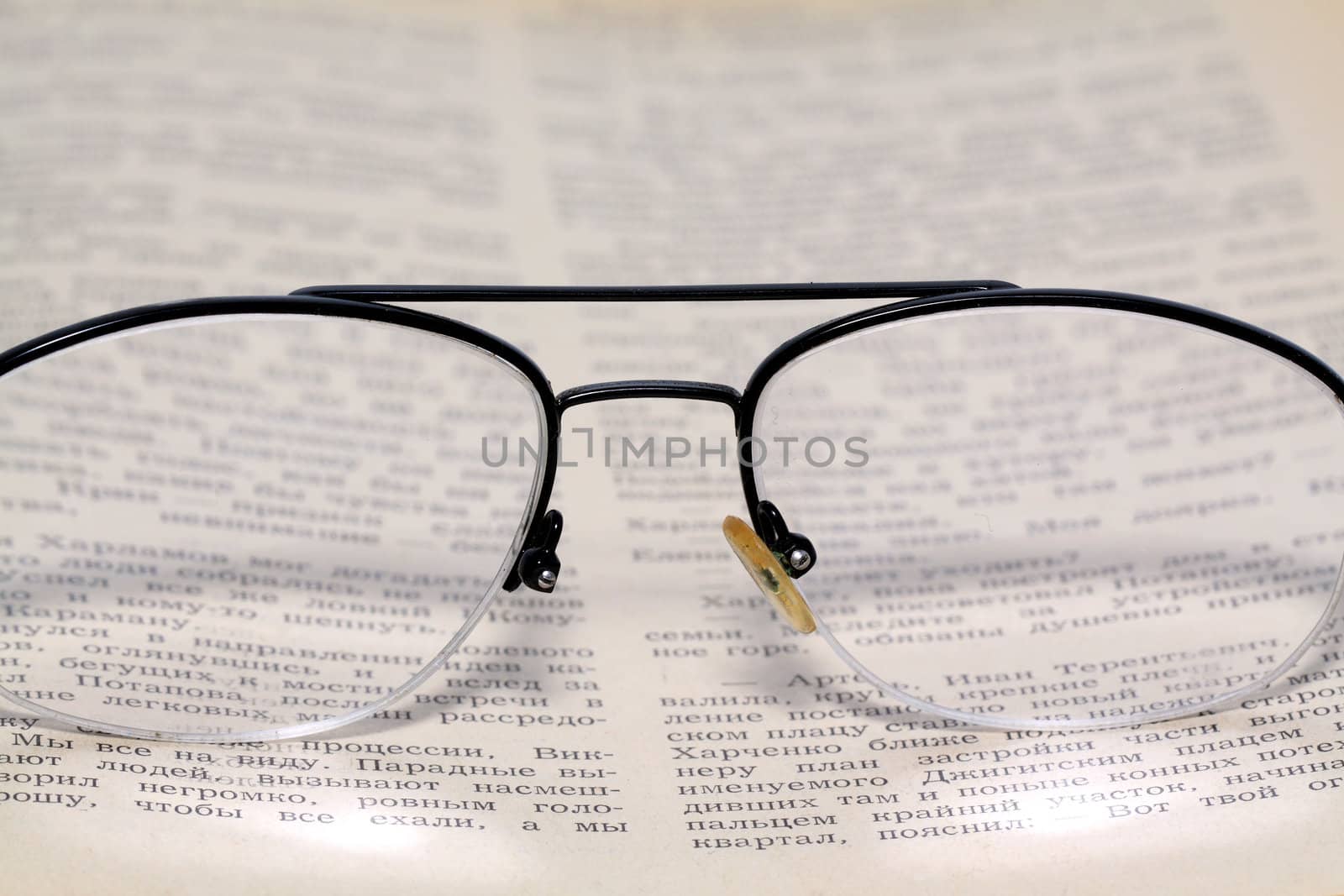 spectacles on old book