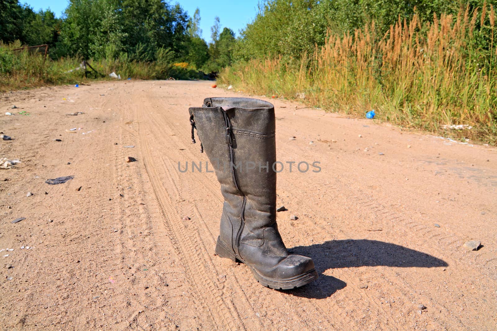 old boot on sandy rural road