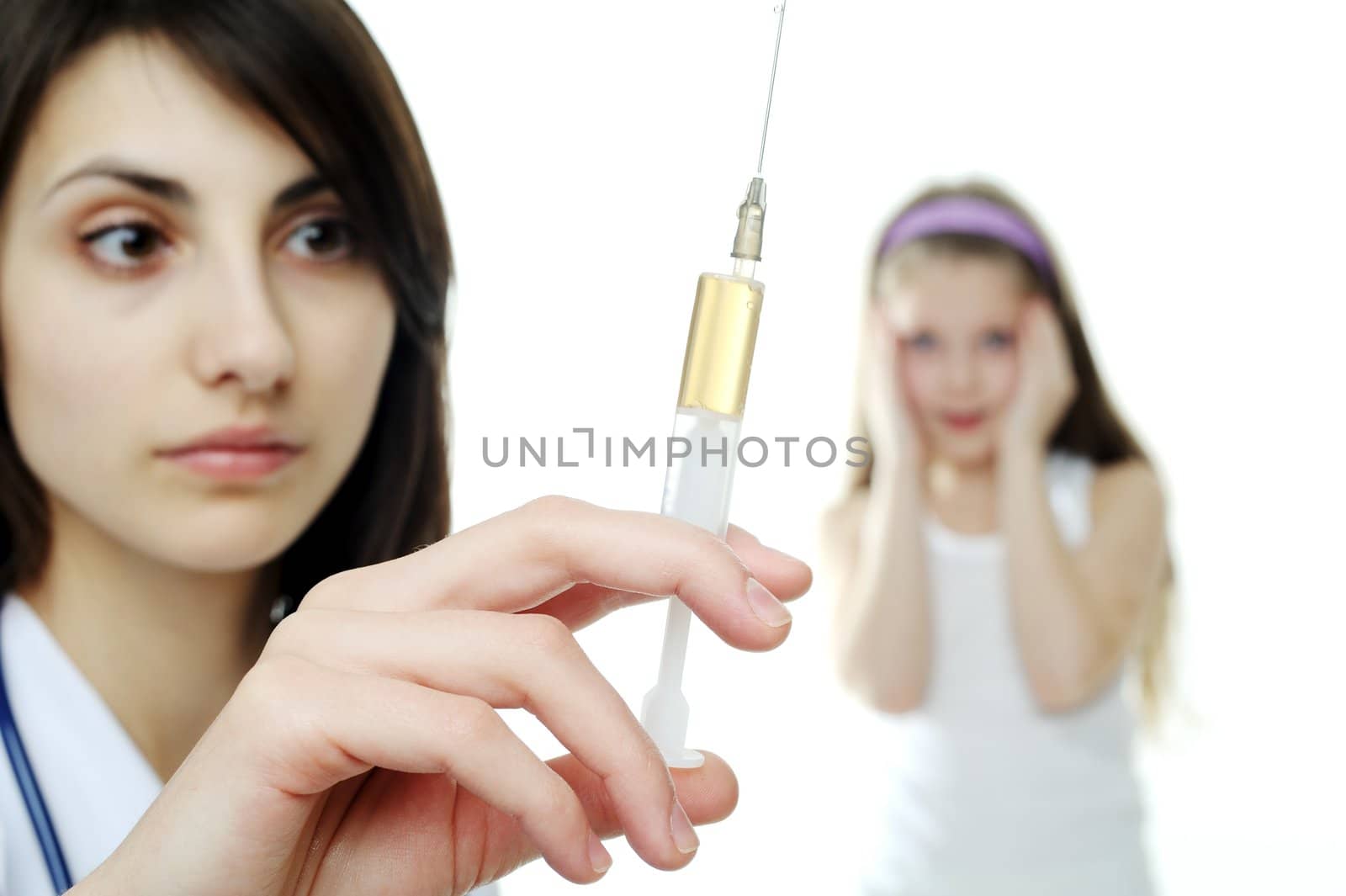 An image of a doctor getting ready to make an injection to a child