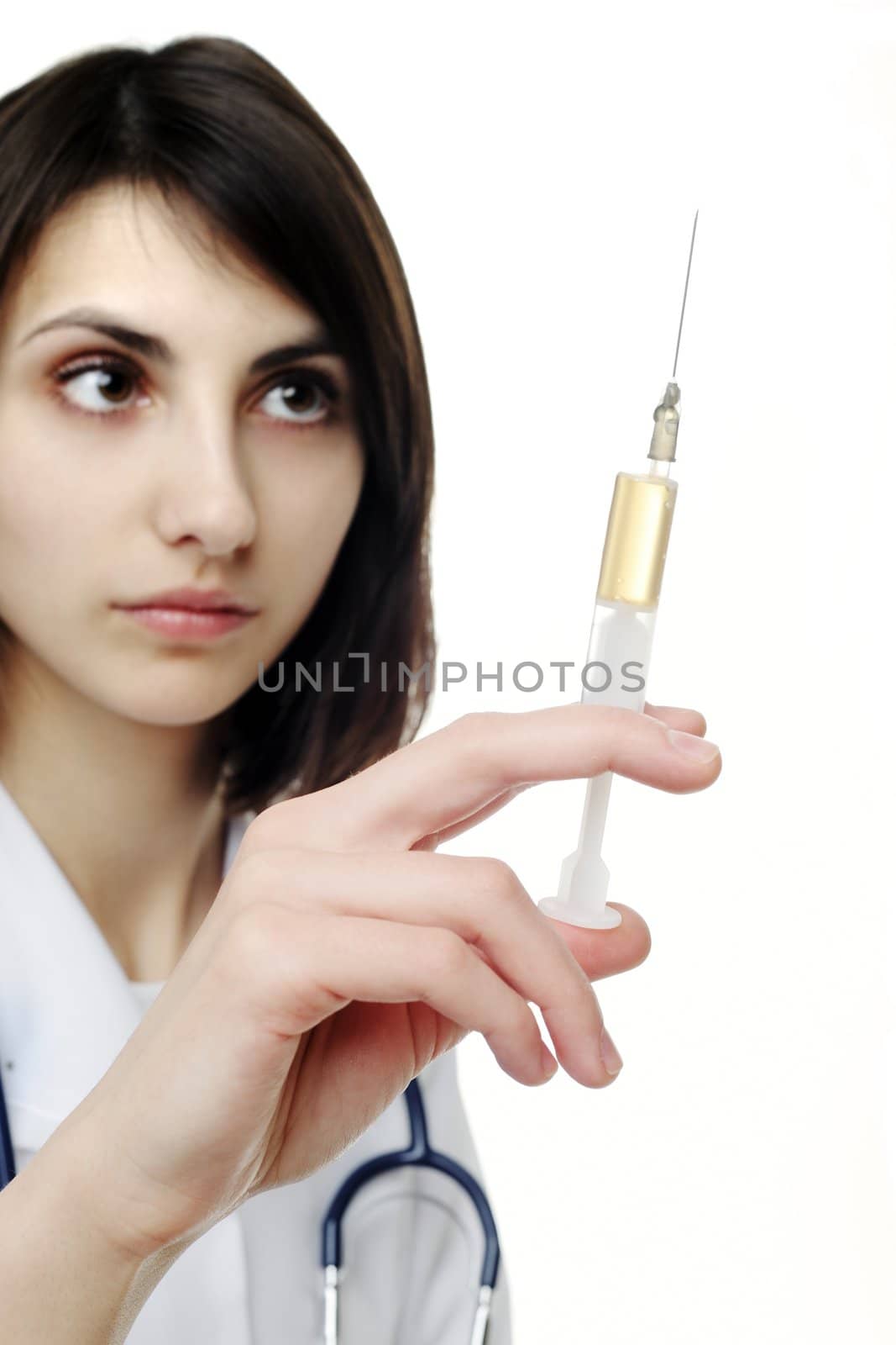 Doctor getting ready to make an injection to a young girl