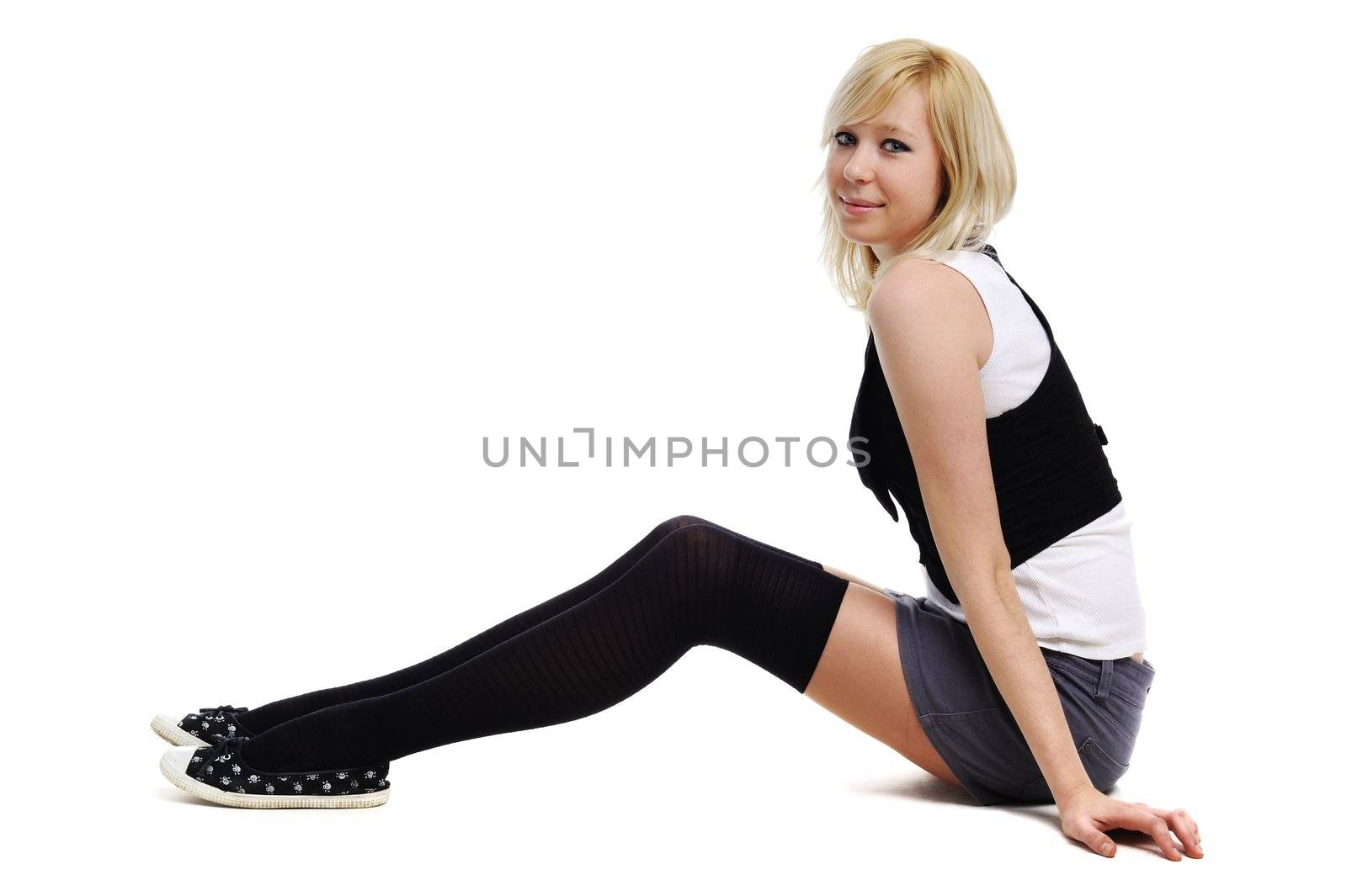 A portrait of a beautiful girl sitting on the floor