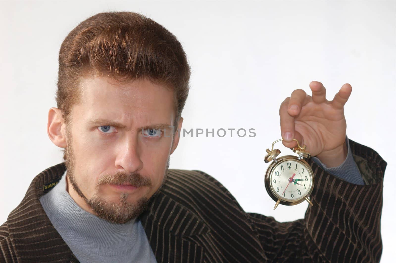 A man keeping an alarm clock in his hand