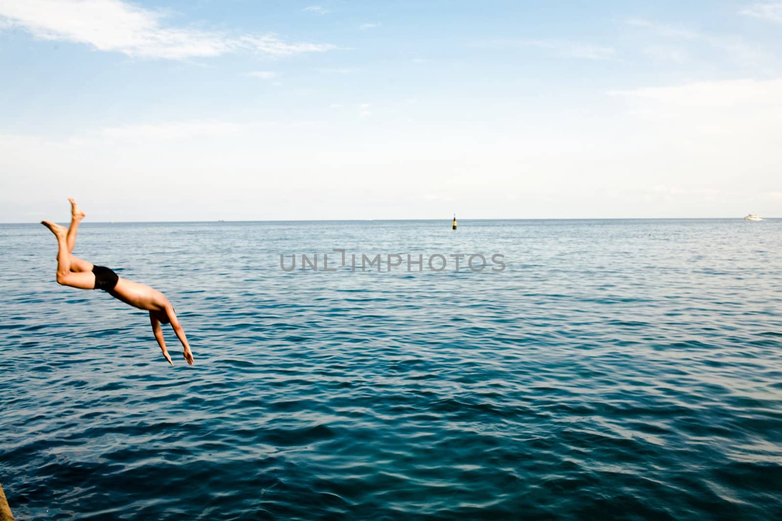 An image of men jumping in ocean