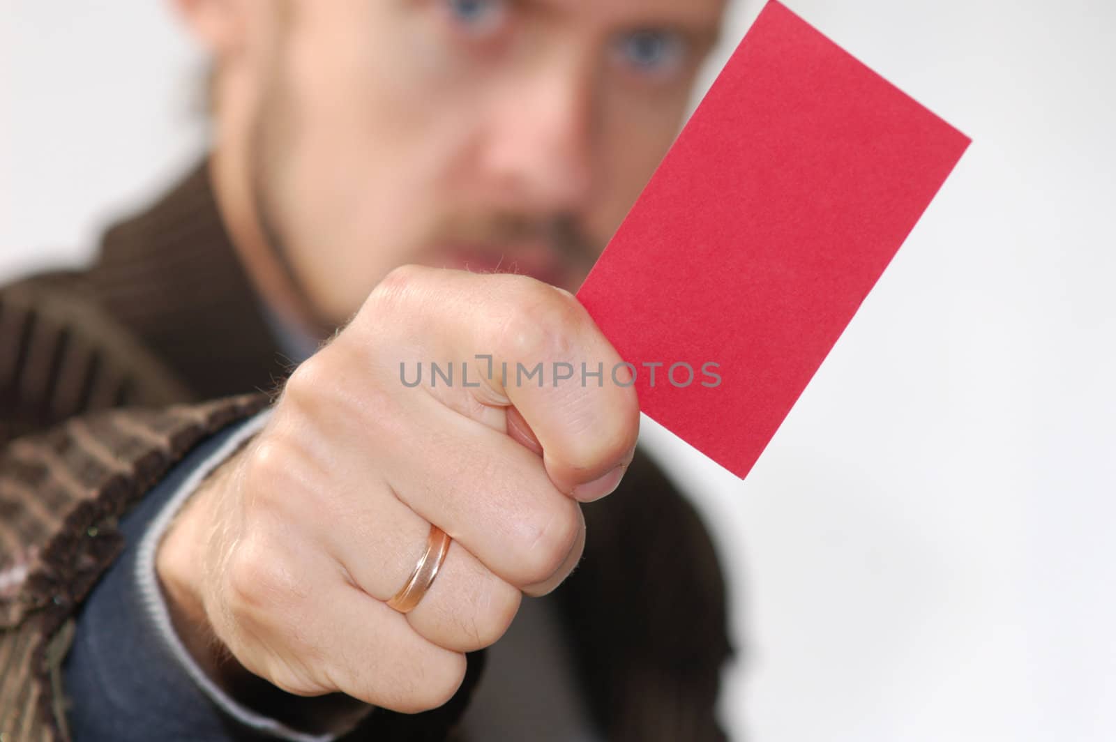 An image of men showing red card